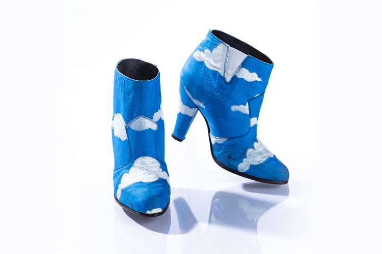 Prince rocked these iconic blue ankle boots with hand-painted white clouds in his "Raspberry Beret" music video, along with a matching suit.