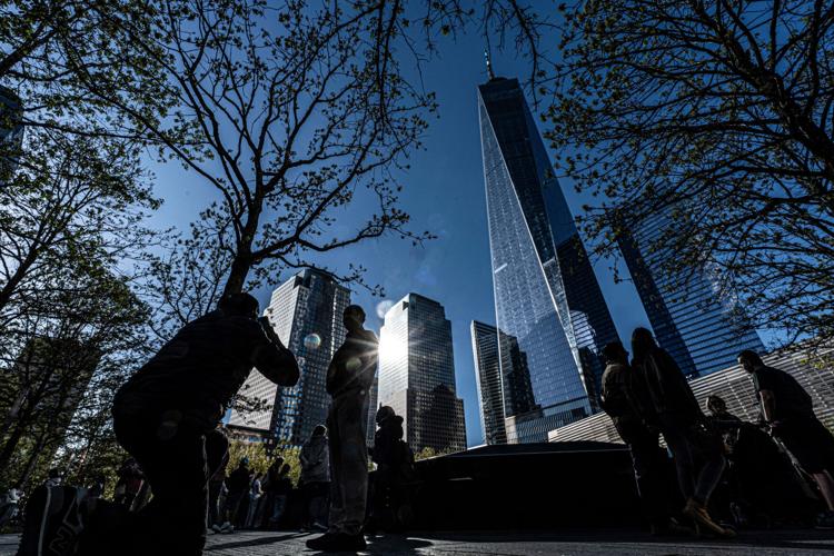 Visitors take photos of themselves with One World Trade Center behind them as they spend time at the 9/11 Memorial in Manhattan April 27, 2026. The National September 11 Memorial & Museum has become one of the most visited destinations for tourists vis