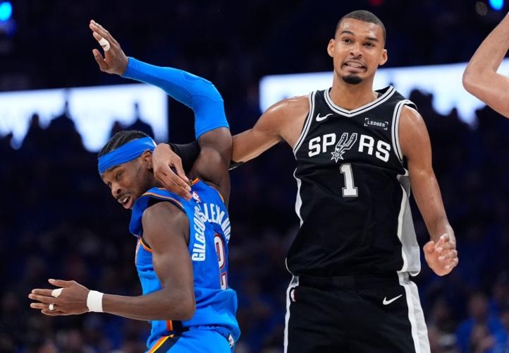 Oklahoma City's Shai Gilgeous-Alexander (2) and San Antonio's Victor Wembanyama (1) fight for position during Game 7 of the Western Conference Finals in the NBA playoffs between the Oklahoma City Thunder and the San Antonio Spurs at Paycom Center in Oklaho