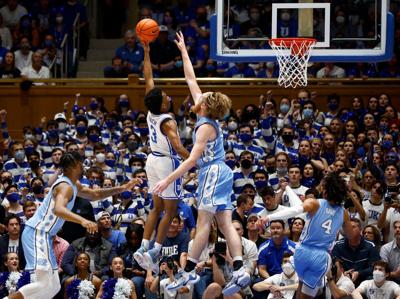 Duke's Jeremy Roach attempts a shot against North Carolina's Brady Manek at Cameron Indoor Stadium on March 5, 2022, in Durham, North Carolina.