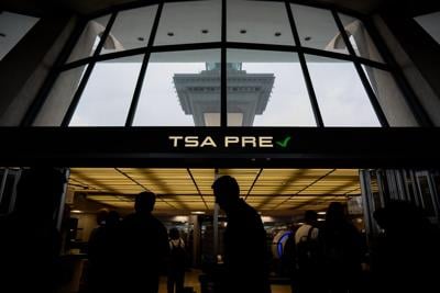 Travelers move through security at Washington Dulles International Airport on May 22, 2026, in Dulles, Virginia.