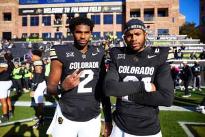 Nov 29, 2024; Boulder, Colorado, USA; Colorado Buffaloes quarterback Shedeur Sanders (2) and safety Shilo Sanders (21) before the game against the Oklahoma State Cowboys at Folsom Field. Mandatory Credit: Ron Chenoy-Imagn Images