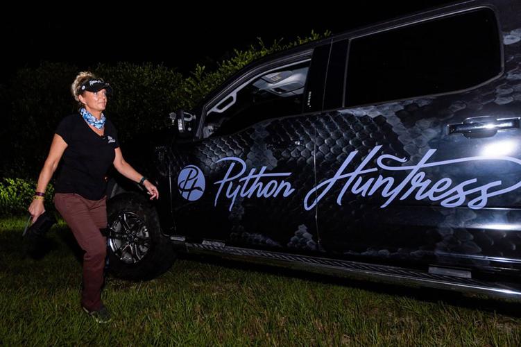 Python Huntress Amy Siewe walks to her truck during a hunting trip down Tamiami Trail on Sept. 5, 2024, in Miami.