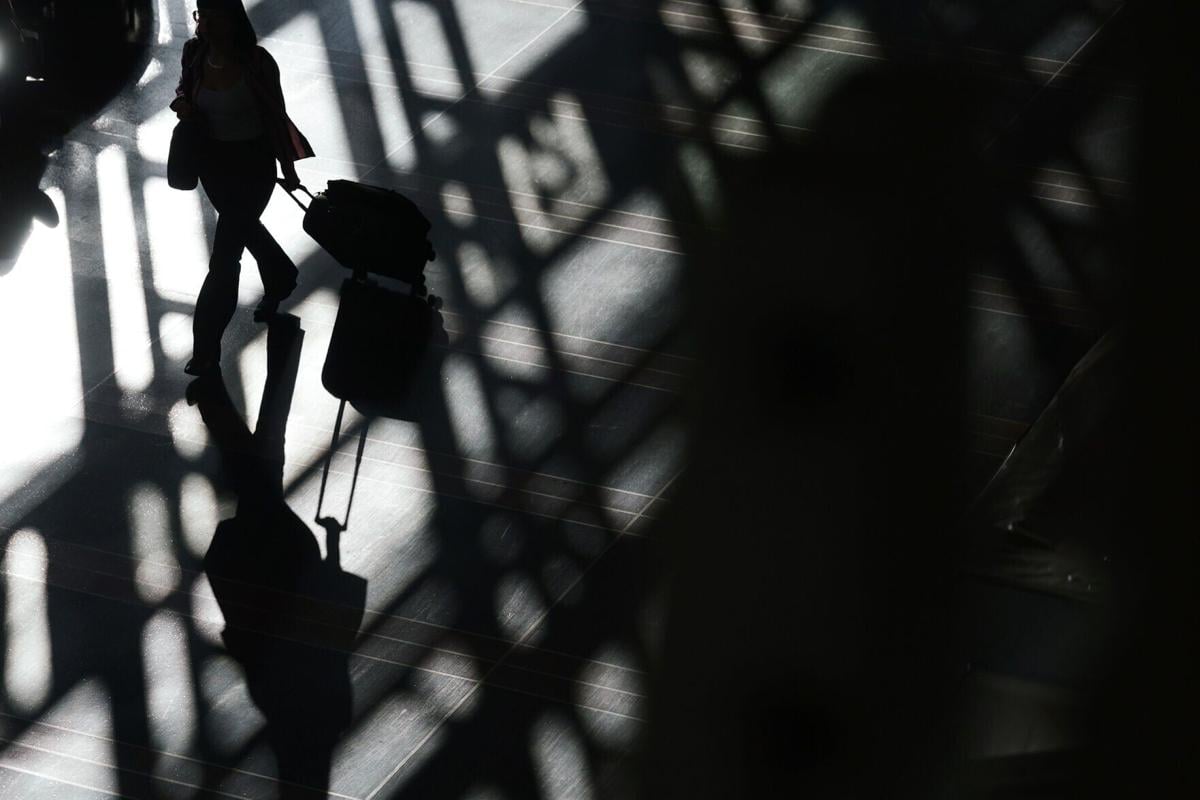 Passengers pass through the concourse at Ronald Reagan Washington National Airport on Oct. 27, 2025, in Arlington, Virginia.