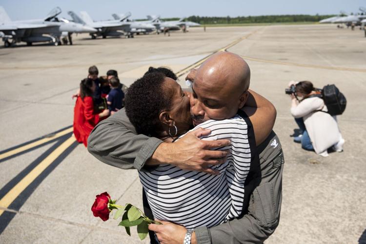 Capt. Alex Hampton hugs his mother Bertha Hampton after returning home with The Pukin Dogs of Strike Fighter Squadron 143 to Naval Air Station Oceana in Virginia Beach, Virginia, on April 21, 2023.