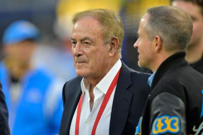 Al Michaels talks with Los Angeles Chargers President of football operations John Spanos prior to the game against the Denver Broncos at SoFi Stadium in 2024.