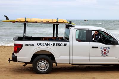 Lifeguards patrol the beach in Virginia Beach, Va., on Sept. 22, 2024 after two swimmers went missing the night before. Rescue efforts were ended late in the night due to rough seas.