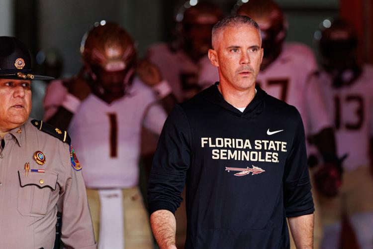 Nov 29, 2025; Gainesville, Florida, USA; Florida State Seminoles head coach Mike Norvell walks out of the tunnel before a game against the Florida Gators at Ben Hill Griffin Stadium. Mandatory Credit: Matt Pendleton-Imagn Images