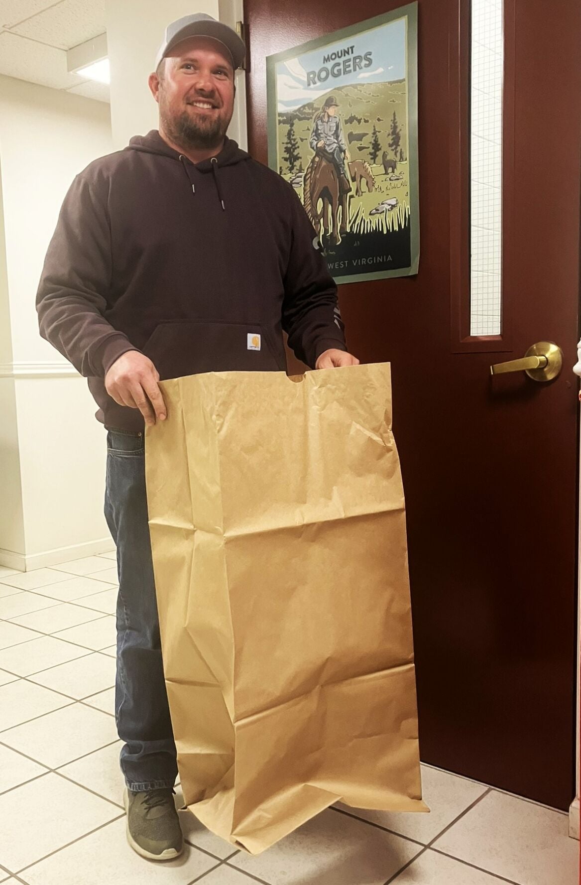 Tyler Keen with yard waste bag