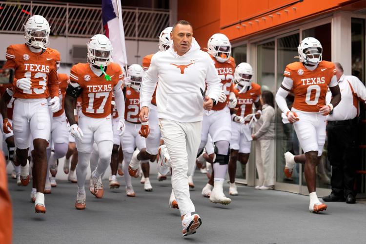 Texas Longhorns head coach Steve Sarkisian leads his team on to the field before a game against the Vanderbilt Commodores at Darrell K Royal-Texas Memorial Stadium.