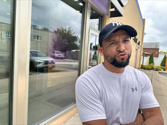Benny Tejeda stands outside a Taco Bell, in Orange