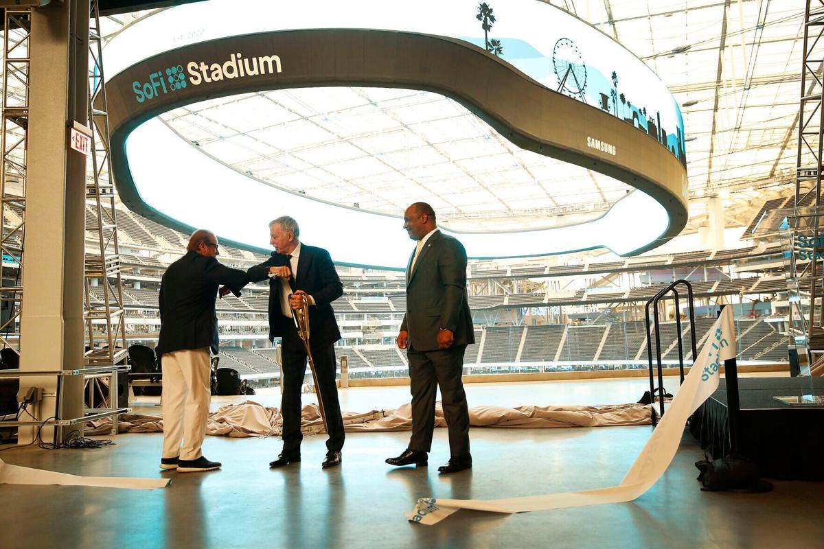 Los Angeles Chargers owner Dean Spanos, left, and Los Angeles Rams owner Stan Kroenke bump elbows at SoFi Stadium with Inglewood, California Mayor James T. Butts nearby during ribbon-cutting ceremony on September 8, 2020.