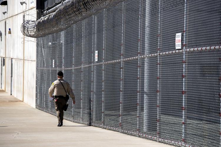 A guard walks inside the perimeter at Mule Creek State Prison on Wednesday, Sept. 6, 2023, in Ione, California.