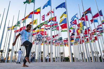 A boy plays with a ball at the flag plaza in Doha, Qatar, on Nov. 15, 2022, ahead of the Qatar 2022 World Cup.