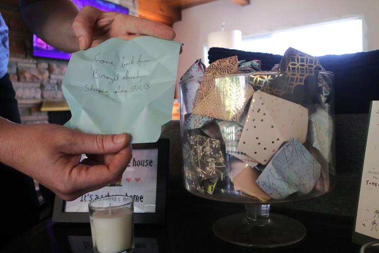 Kris Edwards holds a note from a jar of origami hearts, a Valentine’ s Day gift from his wife, Erika“ Tilly” Edwards, after the couple got engaged seven years ago. He has yet to open all the hearts, which contain memories, poems, movies and quotes. Inst...