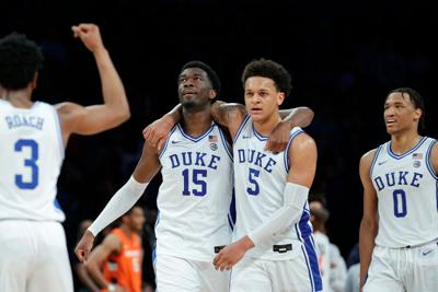 Duke's Paolo Banchero and Mark Williams celebrate amid an 88-79 win against Syracuse in the ACC Tournament quarterfinals at Barclays Center on March 10, 2022, in New York.