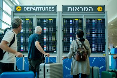 Passengers check the departure board inside the Departure Hall at Ben Gurion International Airport on June 8, 2026, in Tel Aviv, Israel. Aviation officials kept the country's main gateway open following a wave of early morning Iranian missile strikes. I...
