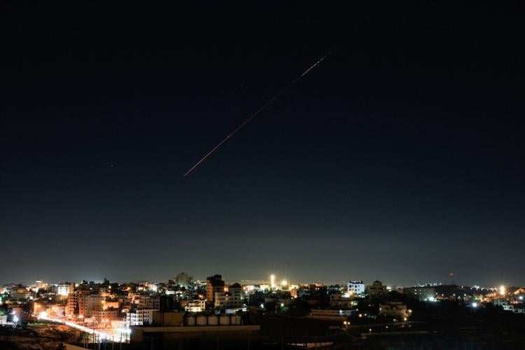 An Israeli air-defence missile flies in the sky over Israel, as seen from Hebron, in the Israeli-occupied West Bank