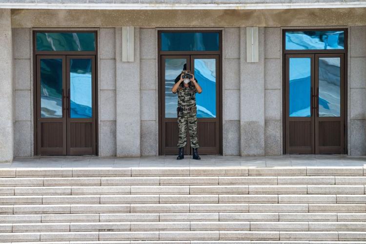 A North Korean soldier observes the DMZ.