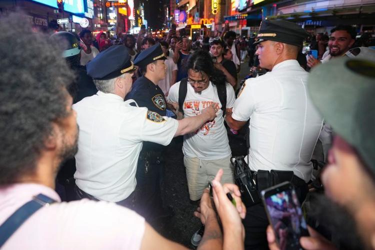 The NYPD arrest a reveler in Times Square after the Knicks win the NBA Championships, Jun 13, 2026, New York, NJ, USA.