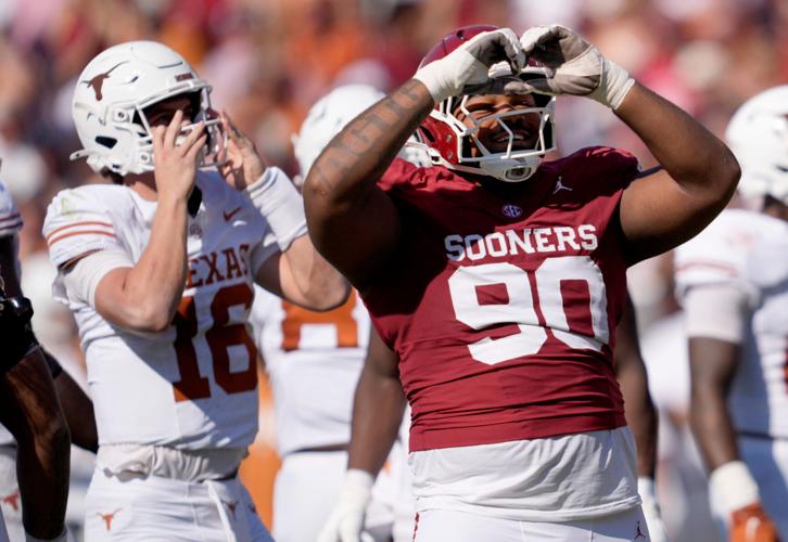 Oklahoma's Trent Wilson (90) celebrates a defensive play next to Texas' Arch Manning (16)  in the first half of the Red River