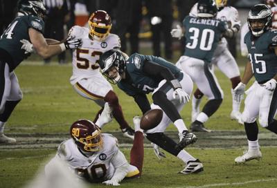 Eagles quarterback Nate Sudfeld fumbles the football against Washington Football Team defensive end Montez Sweat during the fourth quarter on Sunday, January 3, 2021 in Philadelphia.