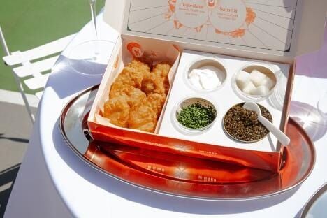 Signature Korean-inspired fried chicken, including COQODAQ's decadent Golden Set of chicken nuggets topped with Petrossian caviar and crème fraîche.