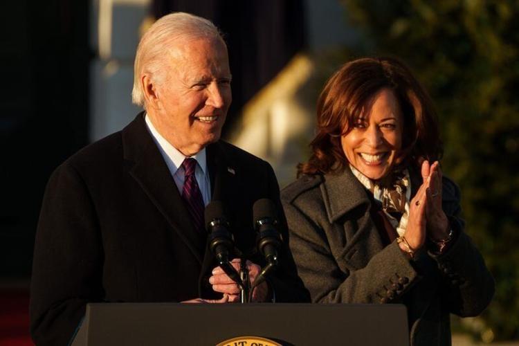 President Joe Biden speaks as Vice President Kamala Harris cheers for him during a ceremony at the White House in 2022.