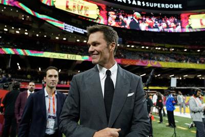 Retired football player and Fox analyst Tom Brady walks the sidelines before the start of Super Bowl LIX between the Kansas City Chiefs and the Philadelphia Eagles at Caesars Superdome in New Orleans, Louisiana, on Feb. 9, 2025.