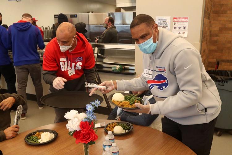 Bills coaches Carrier and Frasier serve food at City Mission