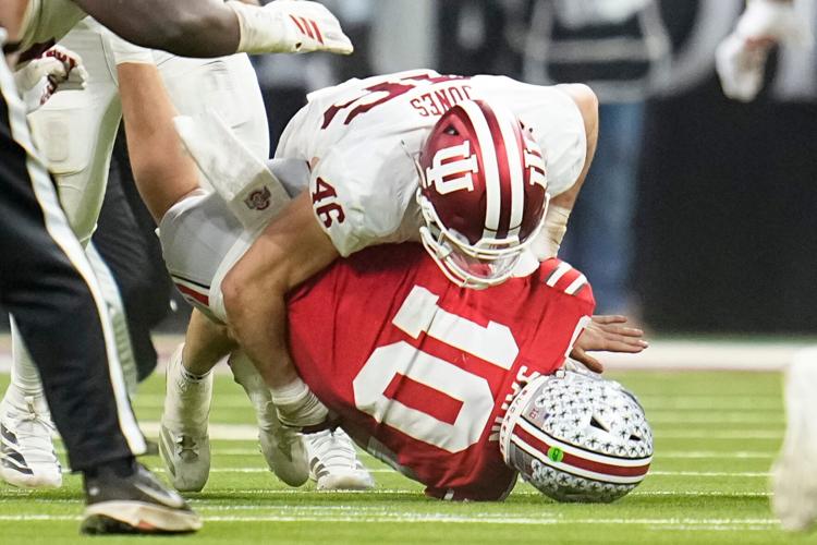 Indiana Hoosiers linebacker Isaiah Jones (46) hits Ohio State Buckeyes quarterback Julian Sayin (10) during the first half of the Big Ten Conference championship game at Lucas Oil Stadium in Indianapolis on Dec. 6, 2025.