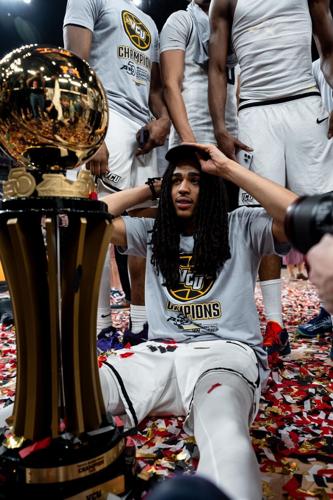 VCU's Brandon Jennings celebrates with A-10 tournament trophy