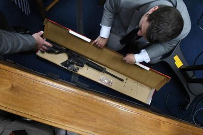 Defense attorney Mark Richards asks Kenosha Police Detective Ben Antaramian to show him Kyle Rittenhouse's rifle and bullets before court begins during the Kyle Rittenhouse trial on Tuesday, Nov. 9, 2021, in Kenosha, Wisconsin.
