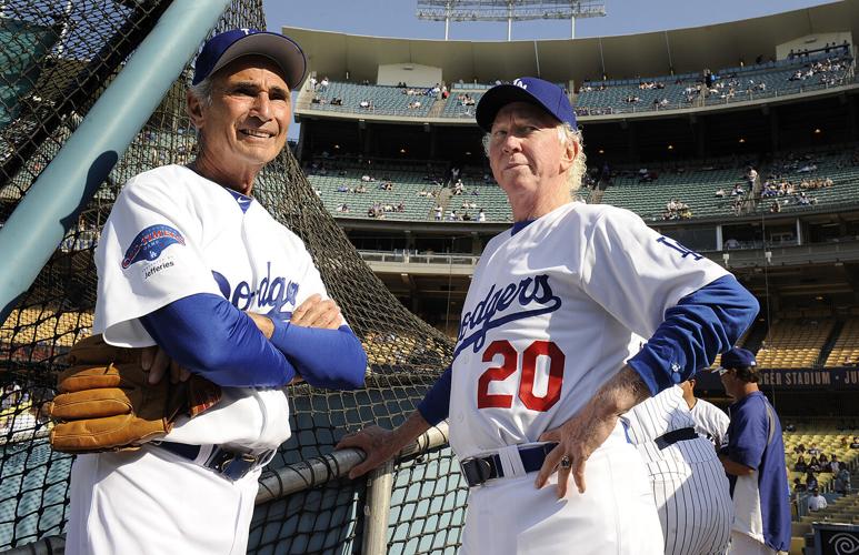 Former Dodger pitchers Sandy Koufax, left, and Don Sutton chat before an old-timers game at Dodger Stadium on Saturday, June 8, 2013. in Los Angeles.