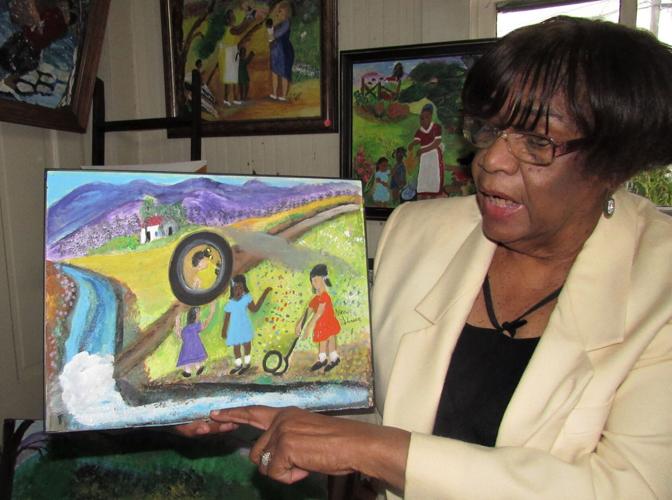 2, Nancy holding painting of children playing games