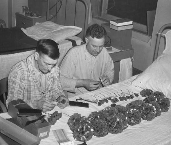 Veterans making poppies for Des Moines Poppy day on Saturday May 29, 1937 at the Veterans Administration hospital, Thirtieth Street and Douglas Avenue. The red crepe paper flowers were made at the hospital by veterans who earn one cent on each poppy mad...