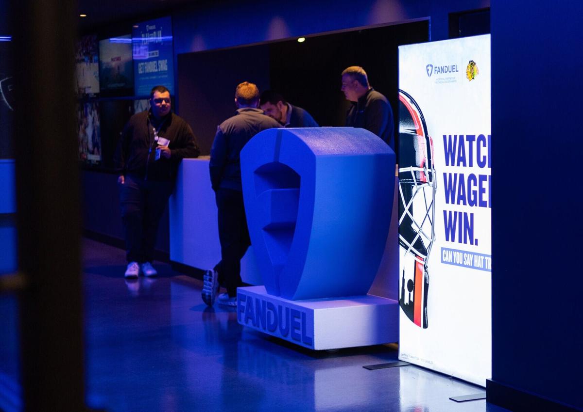 People stand at a table inside the FanDuel Sportsbook bar at the United Center during the Big Ten Men's Basketball Tournament on March 12, 2026, in Chicago.