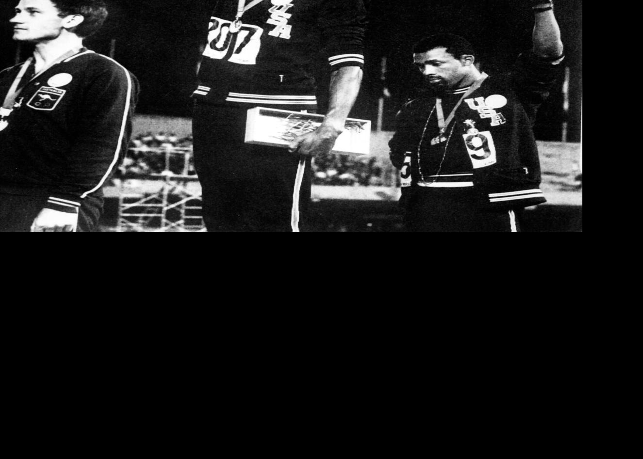 Athletes Tommie Smith, middle, and John Carlos, right, raise their gloved fists in the Black Power salute to express their opposition to racism in the United States during the U.S. national anthem, after receiving their medals October 16, 1968, for firs...