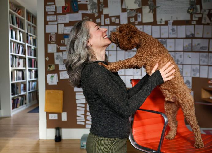 Sara Levine plays with her dog Lenny in her home writing space on Jan. 9, 2026, in Evanston.