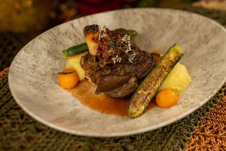 The Moroccan-spiced Lamb Shank at Jiko- The Cooking Place, a signature entree served with couscous, preserved lemon, olives, Marcona almonds and lamb demi-glace.