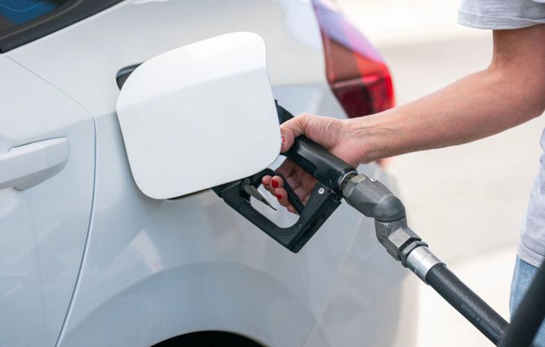 A woman pumps her gas at the Valero gas station which has been turned into a Freedom Fuel, offering Unlead gas for $3.47 a