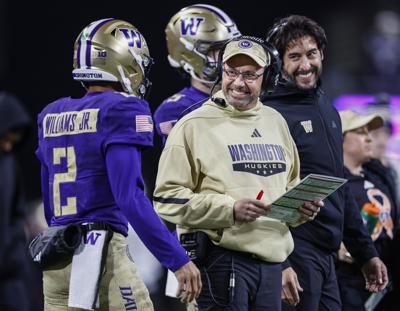 Washington head coach Jedd Fisch smiles at quarterback Demond Williams Jr. as the Huskies get inside the Purdue 5- yard line late in the second quarter at Husky Stadium on Saturday, Nov. 15, 2025, in Seattle.