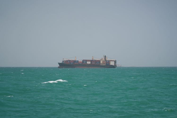FILE PHOTO: A cargo ship sails in Saudi waters near the Dammam Port in Dammam