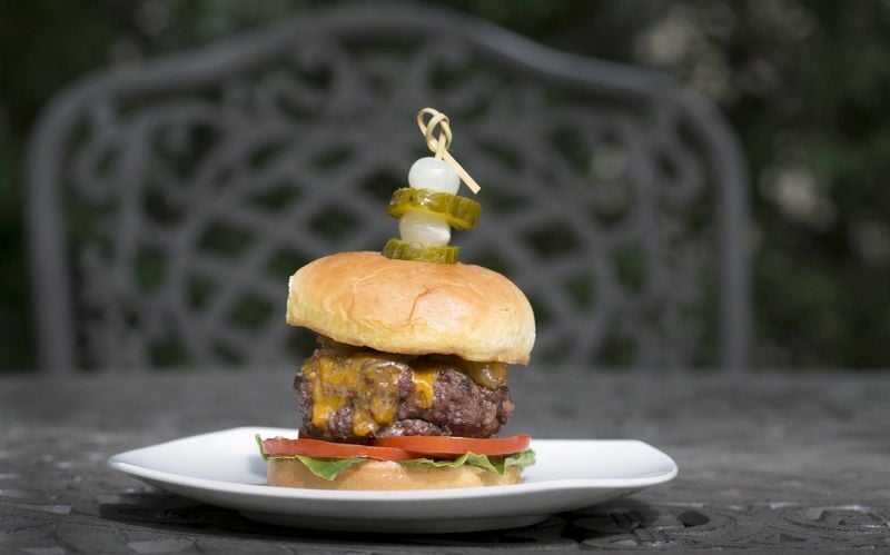 You want to match the size of the patty to the bun. Figure there will be shrinkage, so shape the patty about half an inch larger than the bun.