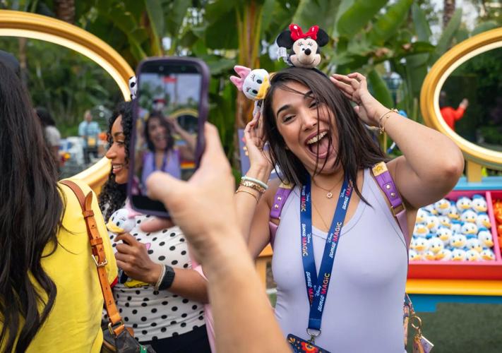 Andrea Hung shows off her new Disney swag that she and other influencers and content creators received as they attend the Somos Magic event.