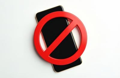 STOCK Black mobile phone with red prohibition sign