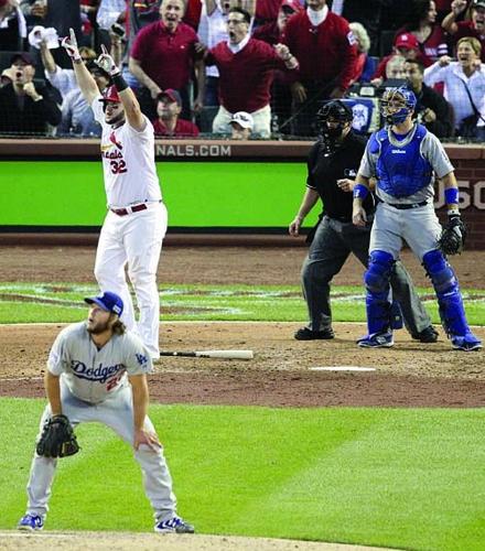 St. Louis Cardinals left fielder Matt Holliday (7) reacts after he hits a  three run home run in the seventh inning against the Los Angeles Dodgers in  game one of the 2014
