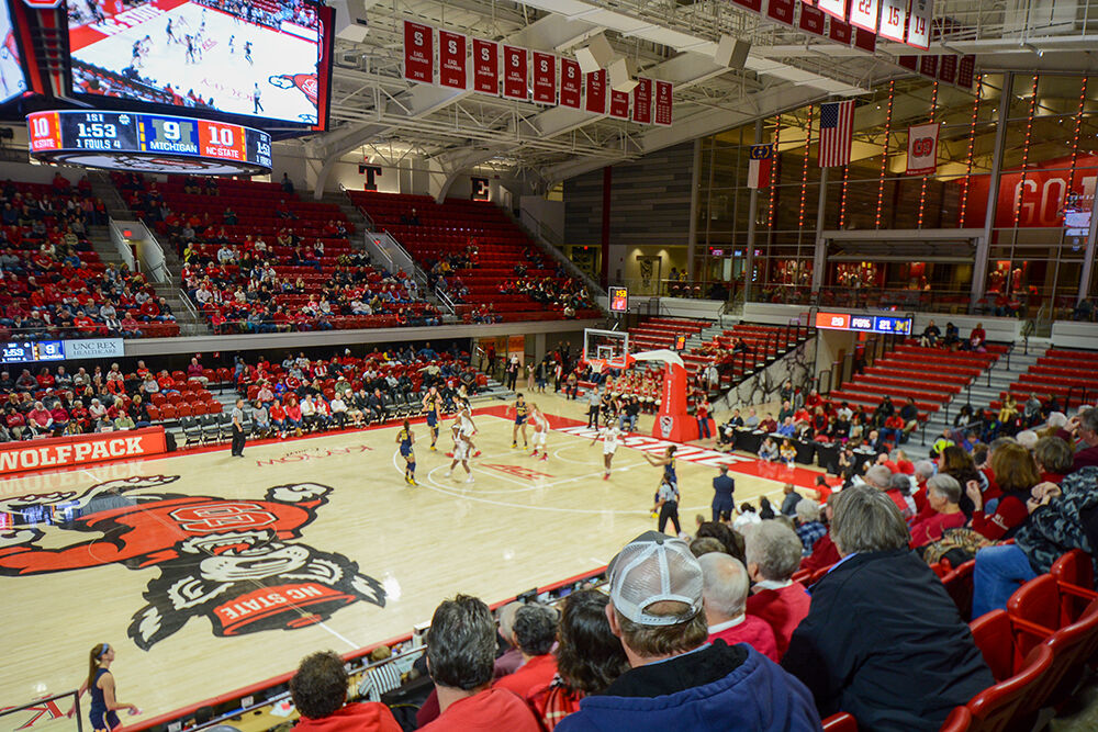 NC State fans rush court at PNC Arena after walloping Duke 