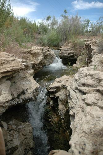 Small waterfall with water splashing and tumbling over the rocks