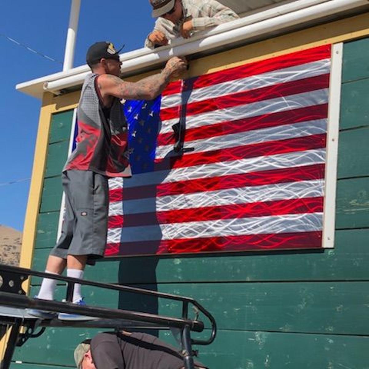 Artist Eric Scarlett Designs Donates Metal Flag To Rodeo News